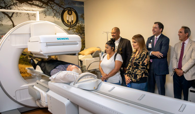 Yocha Dehe Wintun Nation representatives watching a patient go through the Nuclear Medicine Camera