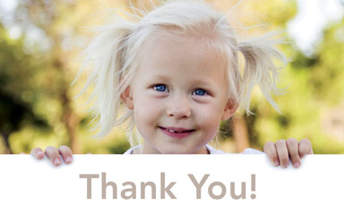 Young girl holding a thank you sign